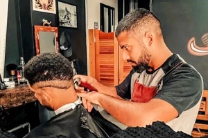 Barber giving a man a close haircut